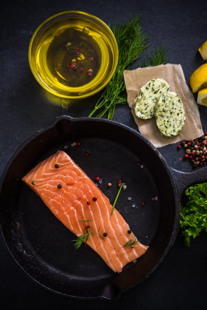 fresh salmon , herbs spices and rustic pan