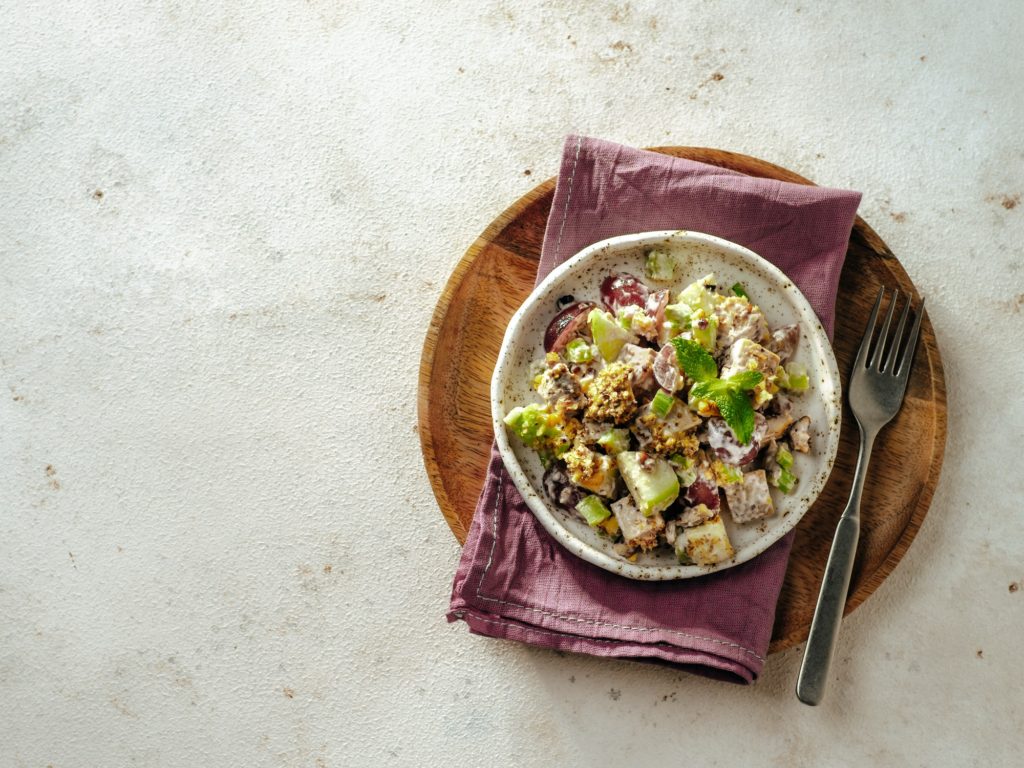 Waldorf salad on white cement,copy space,top view