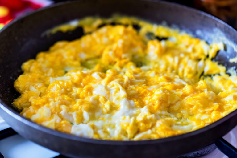 Scrambled egg in frying pan close